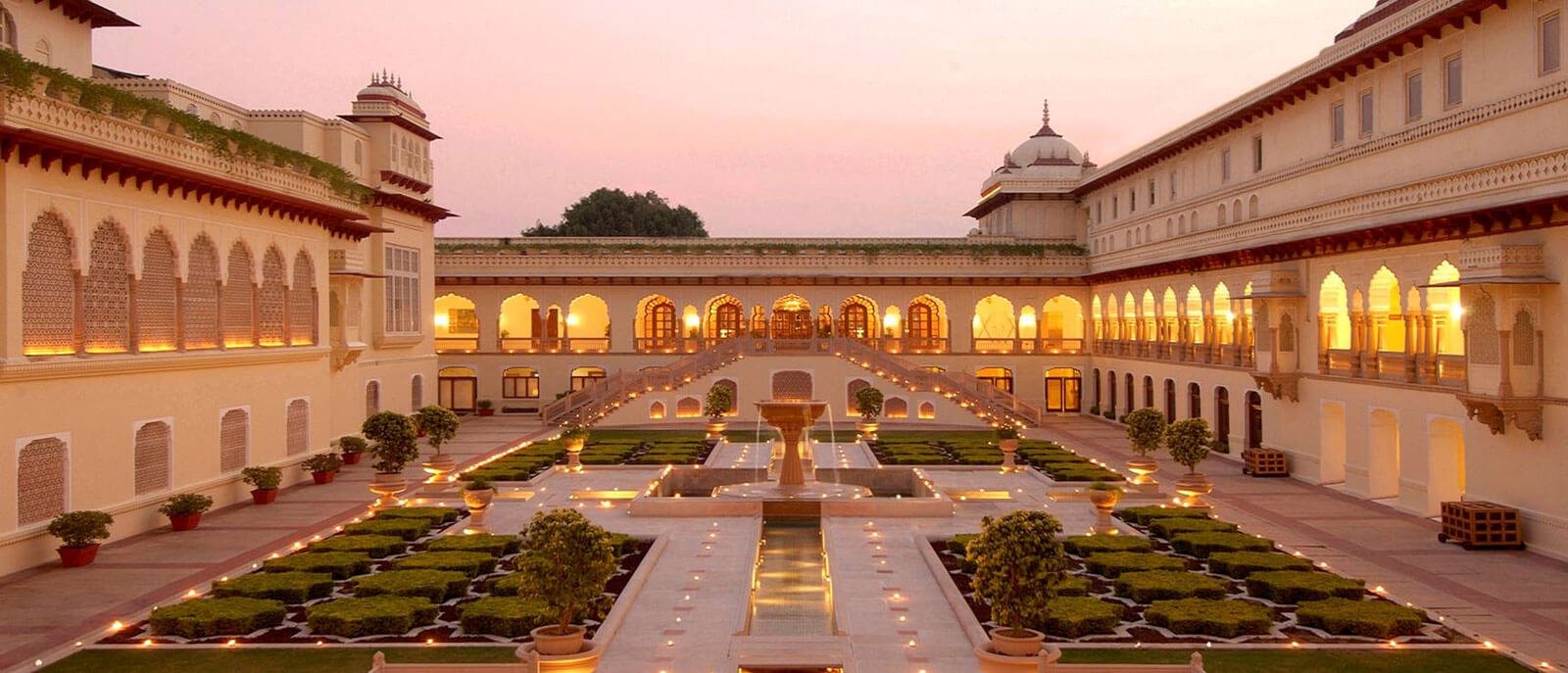 A stunning wedding scene at the Taj Udaipur Hotel, showcasing the beauty of Jaipur, Rajasthan, amidst rural landscapes.